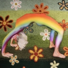 Julia Haw, Rainbow in a Field of Daisies, 2021, punch rug (yarn), monks cloth, oil, and hand-cut oak. On loan from the artist. 
