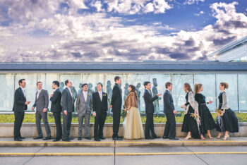 A wedding party stands in front of a Kirk Newman sculpture outside the Kalamazoo Institute of Arts